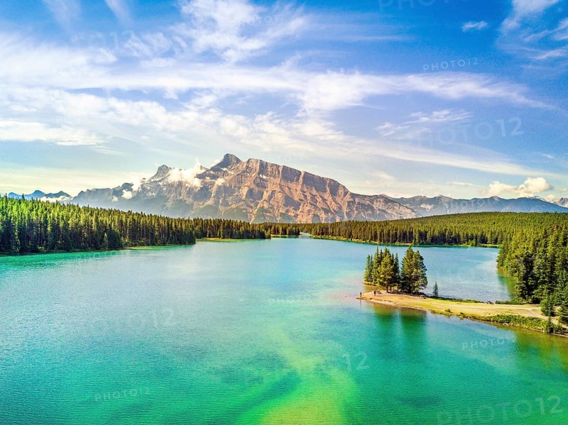 Minnewanka Lake with small peninsula with trees