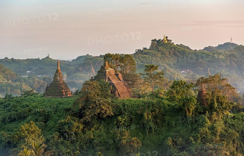 Mist over hills and stupas of Mrauk U at sunset