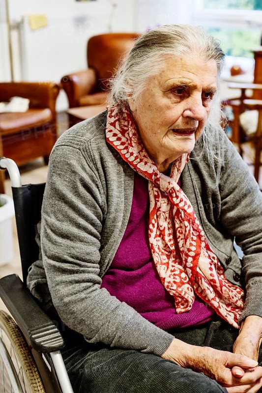 Demented Senior in a wheelchair alone in her room in a nursing home