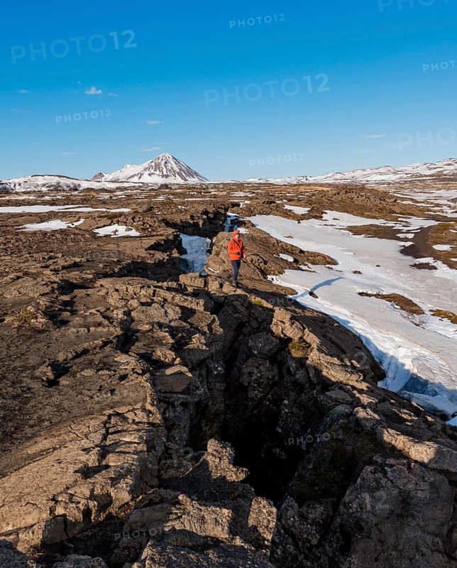 Man stands at Continental Rift between North American and Eurasian Plate