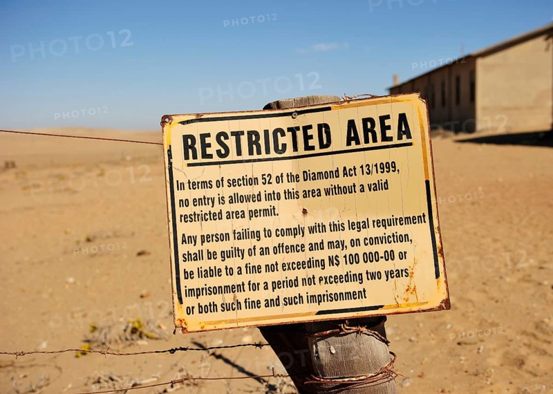 Entrance to the diamond fields Forbidden Shield standing in the sand next to the former diamond city