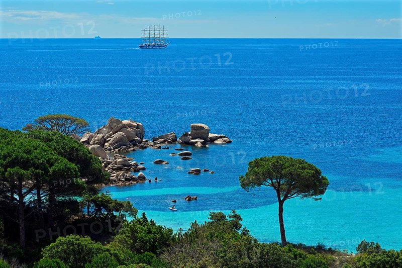 Bay of Palombaggia with turquoise blue sea and sailing ship