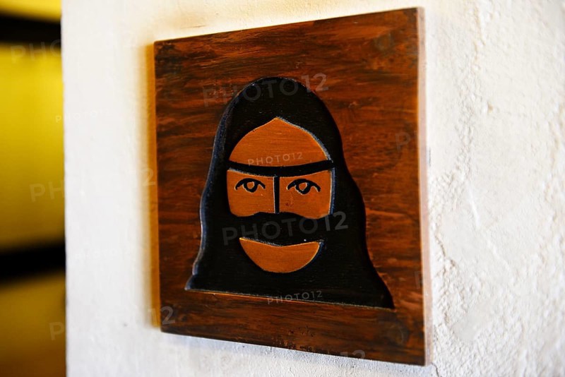 Toilet sign with veiled woman
