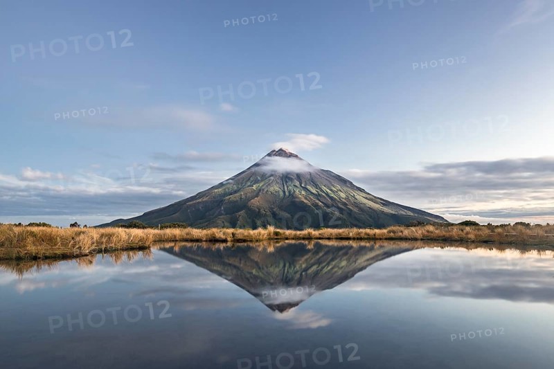 Stratovolcano Mount Taranaki or Mount Egmont reflected in Pouakai Tarn