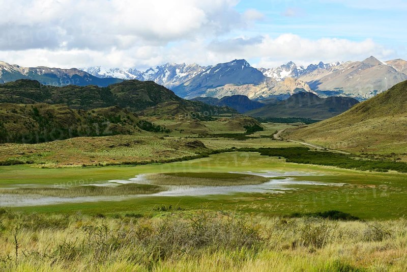 Meandering brook in front of mountain landscape