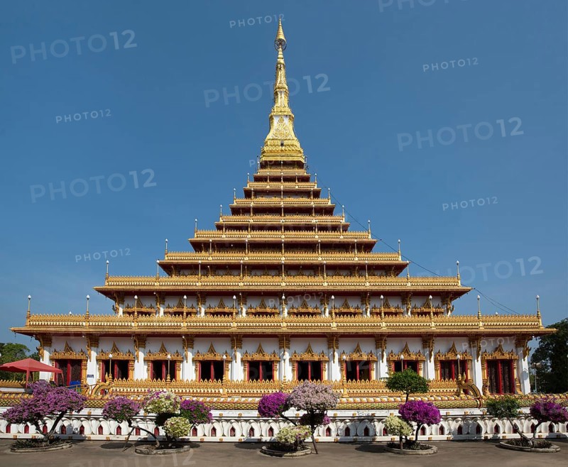 Flowering bushes in front of nine-story stupa Phra Mahathat Kaen Kakhon