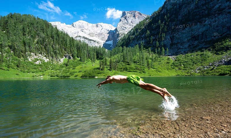 Young man jumps into the water
