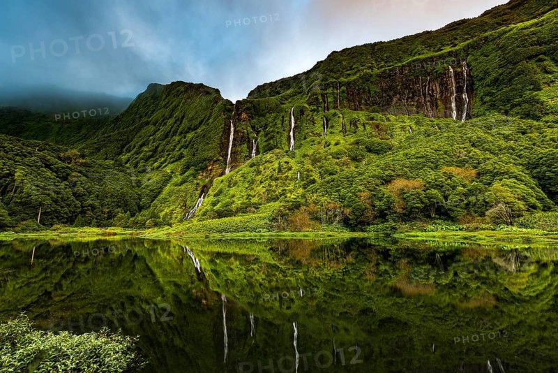 Waterfalls with lake Poco Ribeira do Ferreiro in green landscape