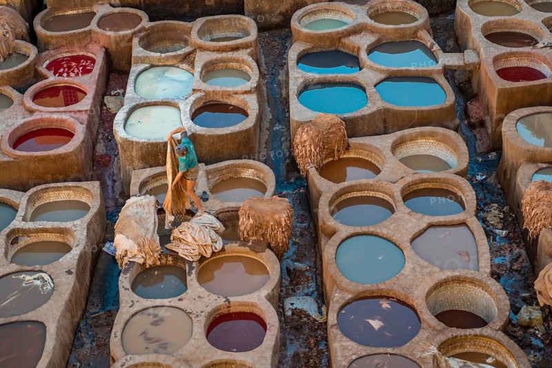 Worker dyeing leather