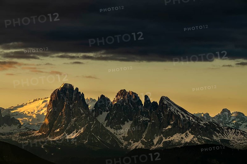 Sunrise with dark clouds over South Tyrolean mountain range