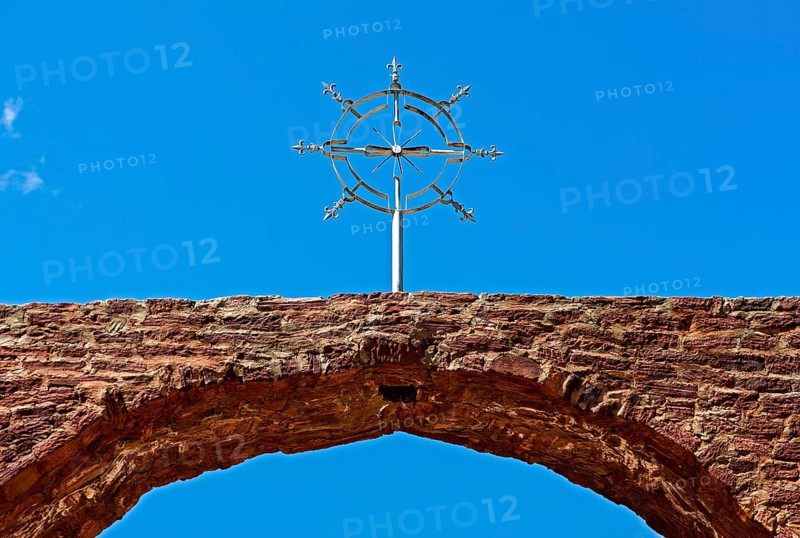 Stylized cross of the orthodox Ethiopian church at the entrance portal to the church Abreha wa Atsbaha