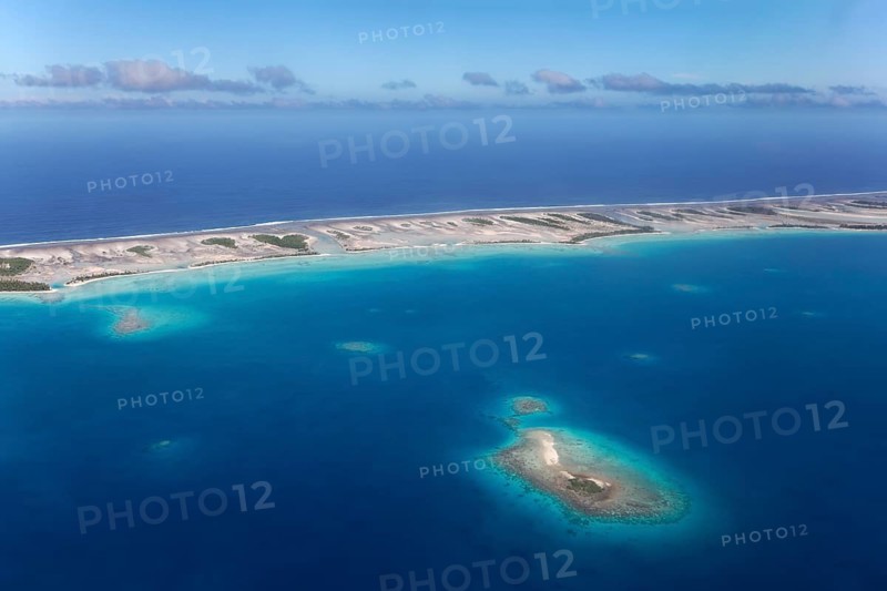 Island in the coral reef with clouds
