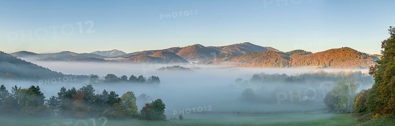 Autumn foggy atmosphere with Schneeberg and pilgrimage church Hafnerberg