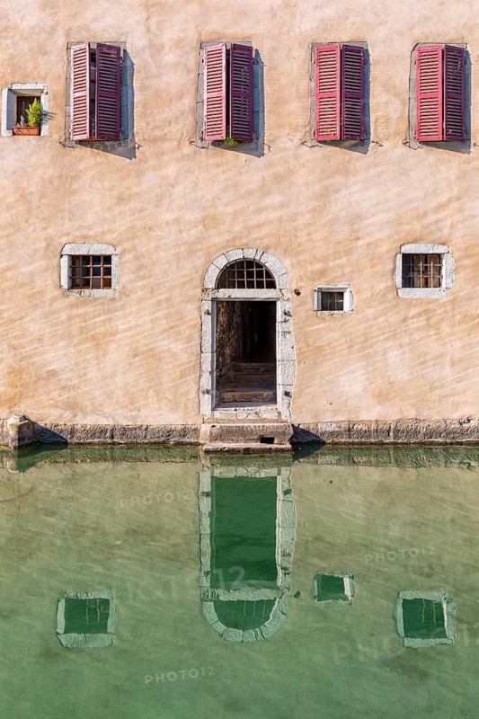 Water reflection of an house at the canal