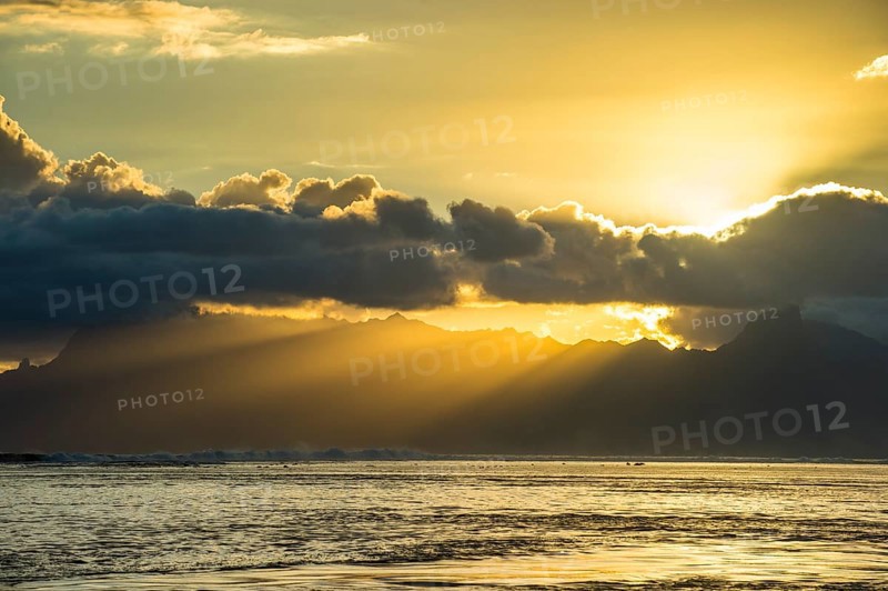 Sun rays breakig through the clouds over Moorea
