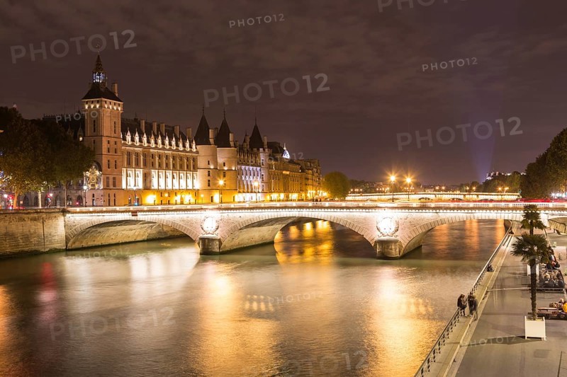 Conciergerie and Pont au Change on the banks of the Seine at night
