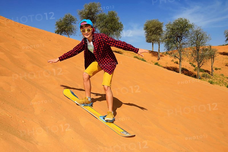 Tourist with Snowboard on the Dune