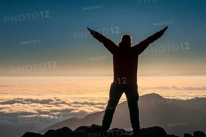 Tourist in backlight waiting for sunset on top of Haleakala National Park