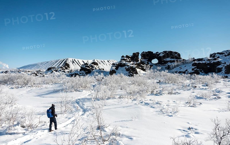 Man on hiking trail in the snow in sunshine