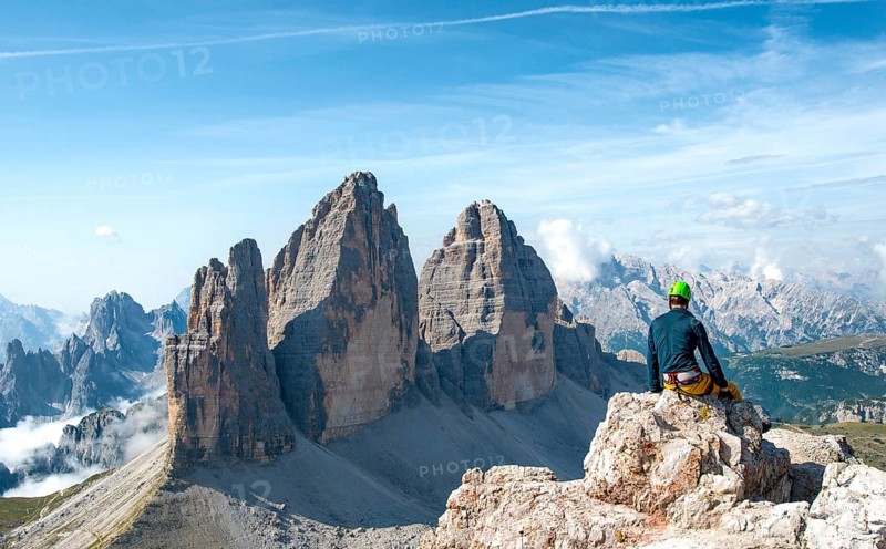 Hiker sits at the summit of the Paternkofel