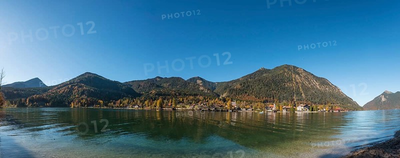 View over the lake with Jochberg and Herzogstand and place Walchensee in autumn