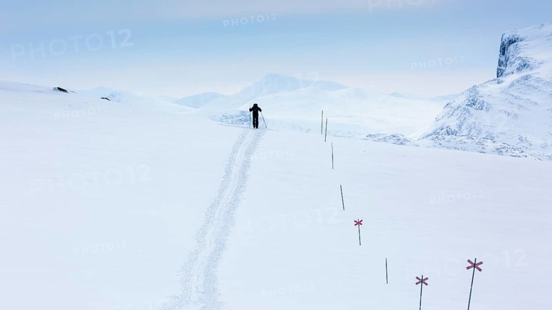 Ski tourer with pulka in the snow