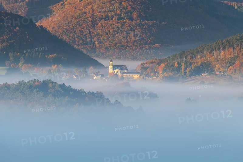 Autumn foggy atmosphere and pilgrimage church at Hafnerberg