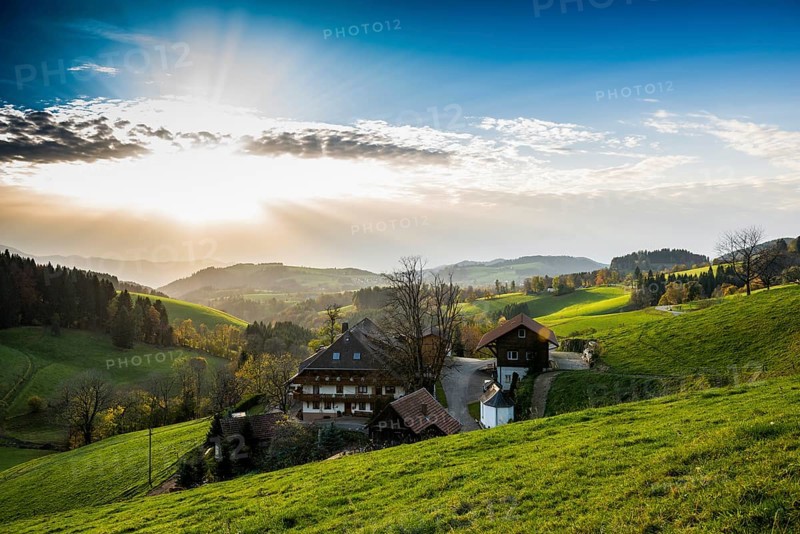 View of hilly landscape with farmhouse