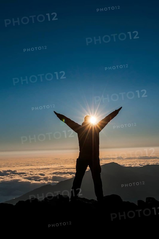 Tourist in backlight waiting for sunset on top of Haleakala National Park