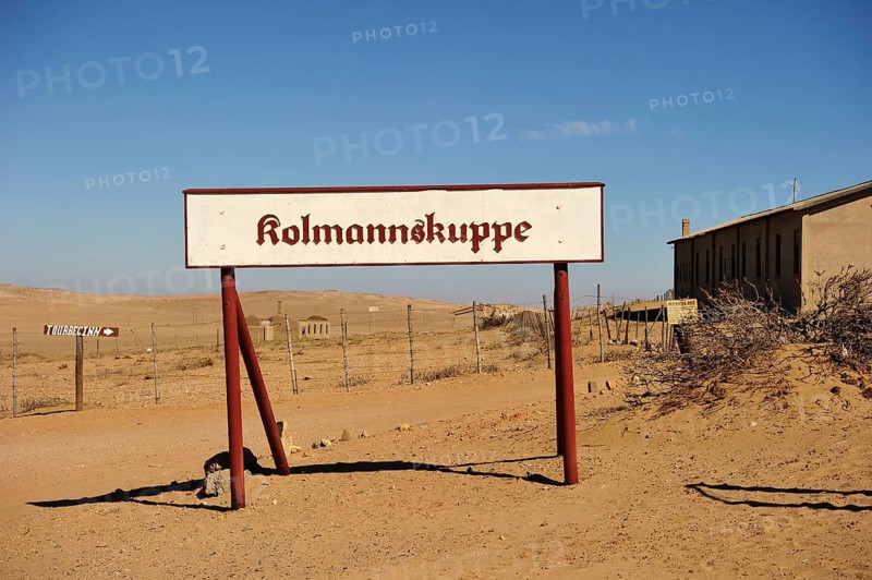 Kolmanskop sign standing in front of the former diamond town
