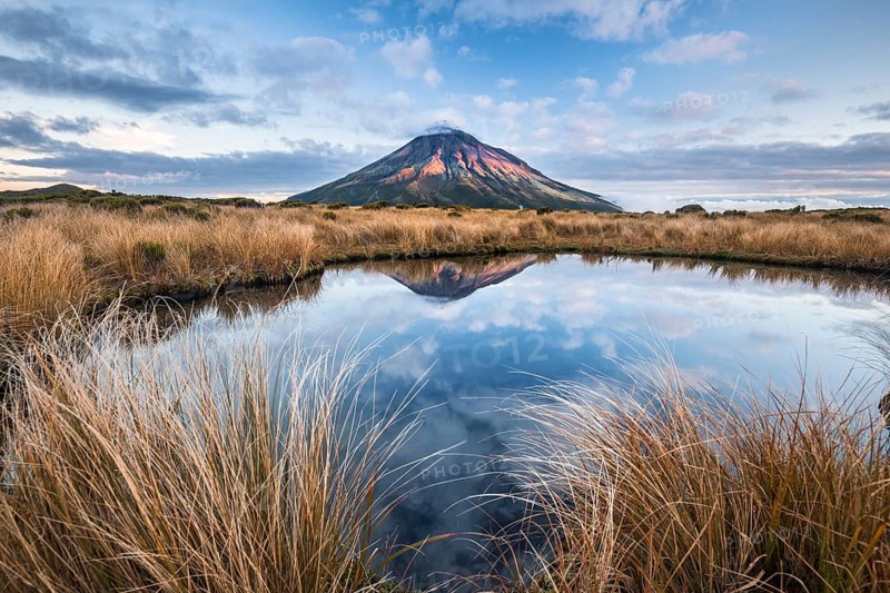 Stratovolcano Mount Taranaki or Mount Egmont reflected in Pouakai Tarn
