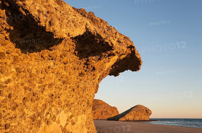 Fossilized lava tongues and walls at the beach Playa del Monsul