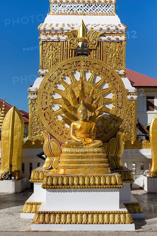Wheel of Life and Golden Buddha Figure at the Chedi of Wat Mahathat Temple
