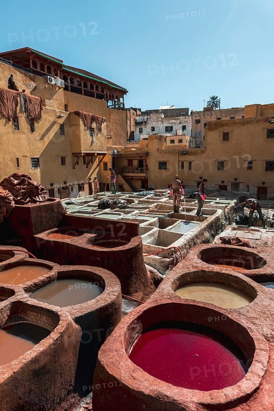 Worker dyeing leather