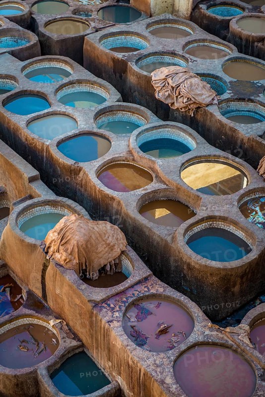 Worker dyeing leather