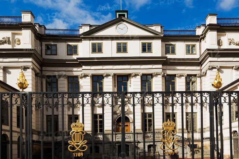 Swedish Supreme Court building with ornate black wrought iron gate with golden crown details