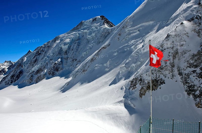 Swiss flag in front of Aletschhorn with snow