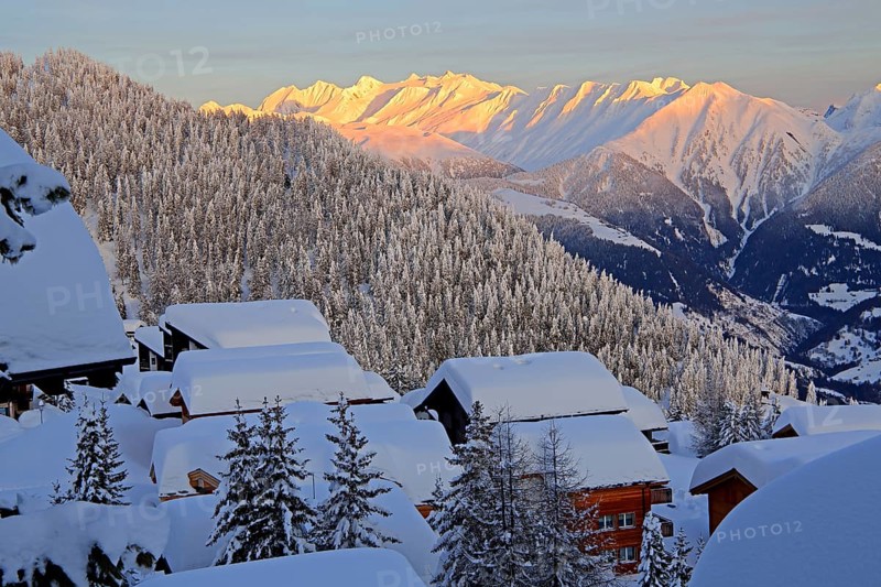 View over deeply snow-covered chalets into the Rhone valley to the Blinnenhorn 3374m and Oberrappenhorn 3176m