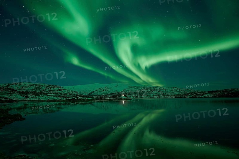 Aurora borealis with water reflection in the fjord