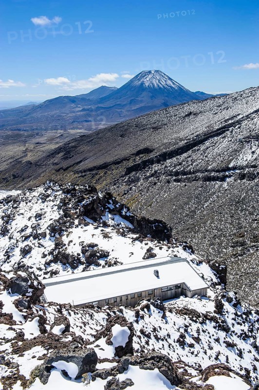 View from Mount Ruapehu on Mount Ngauruhoe with a ski cottage in the foreground