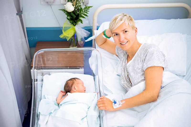 Happy mother enjoying her newborn baby boy still in the hospital