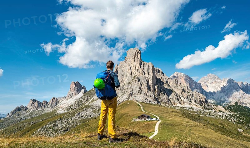 Hiker looking down to Passo Giau