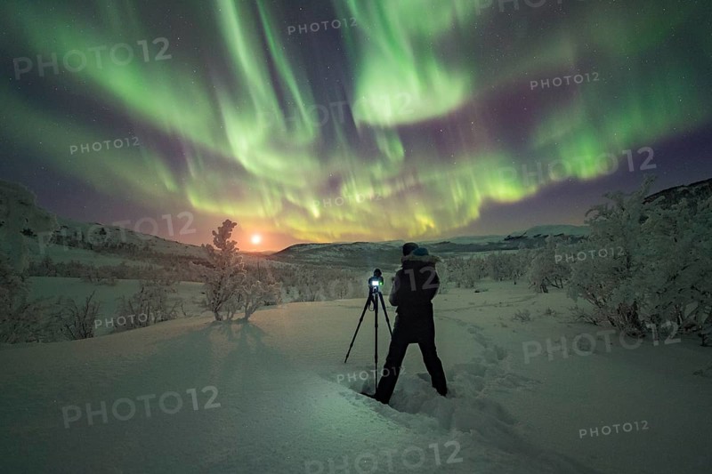 Photographer taking pictures of Northern Lights