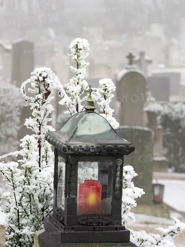 Grave lantern and hoarfrost at the cemetery