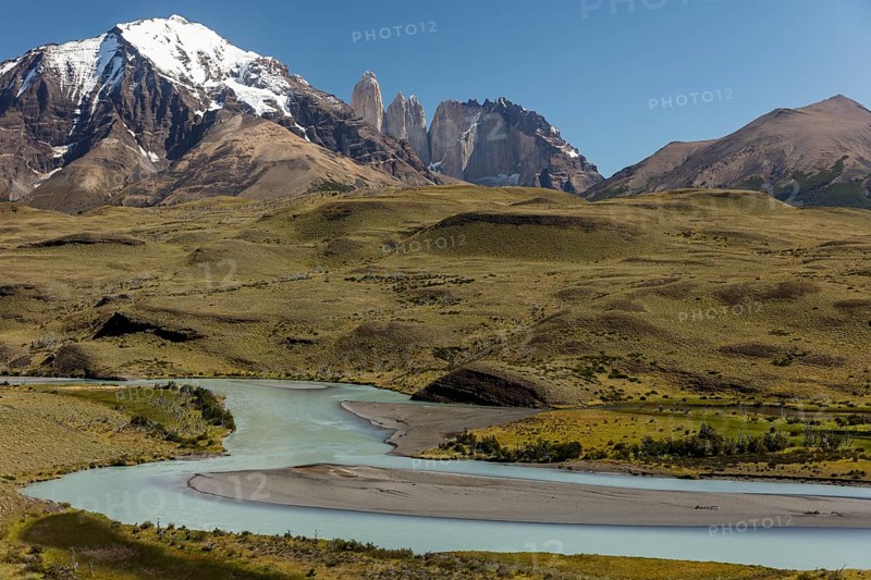 Snow covered peaks of the granite mountains Torres del Paine with the Rio Paine glacial river