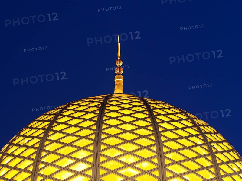 Illuminated dome of the Great Sultan Qabus Mosque at night