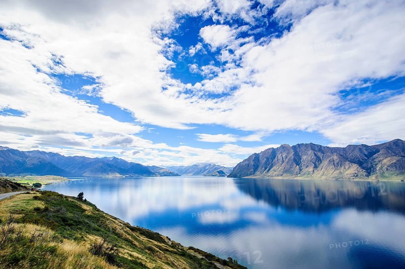Cloudy sky with water reflections in Lake Hawea
