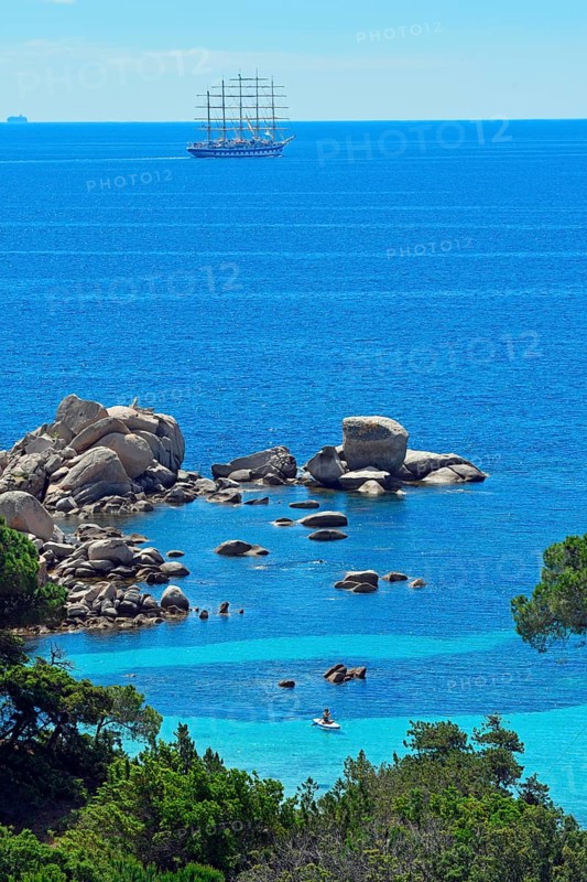 Palombaggia beach with turquoise blue sea and sailing ship