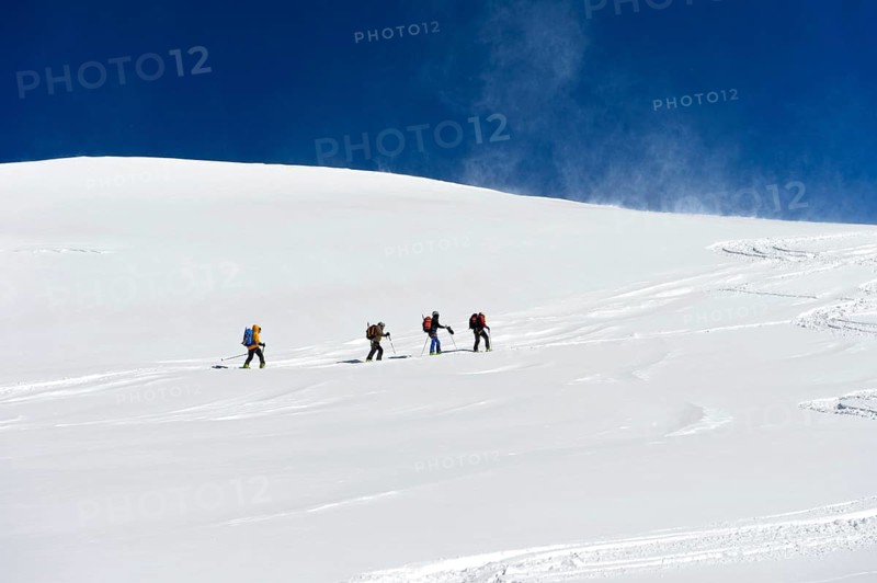 Ski tourers ascending to the summit of Aebeni Fluh