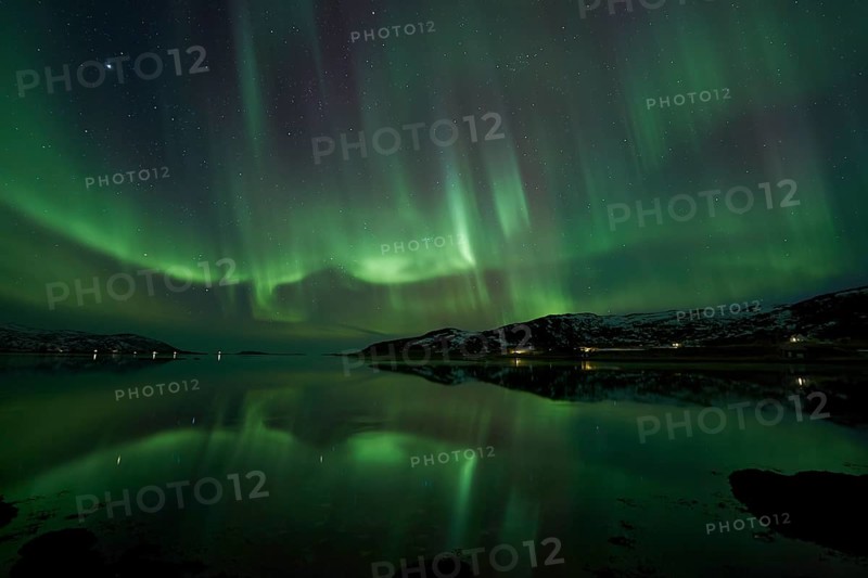 Aurora borealis with water reflection in the fjord